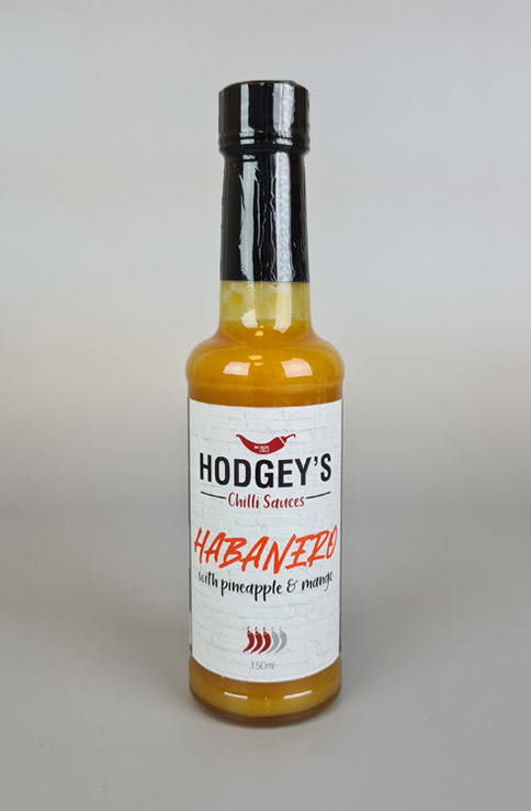 A bottle of Hodgey's Habanero Pineapple & Mango Chilli Sauce